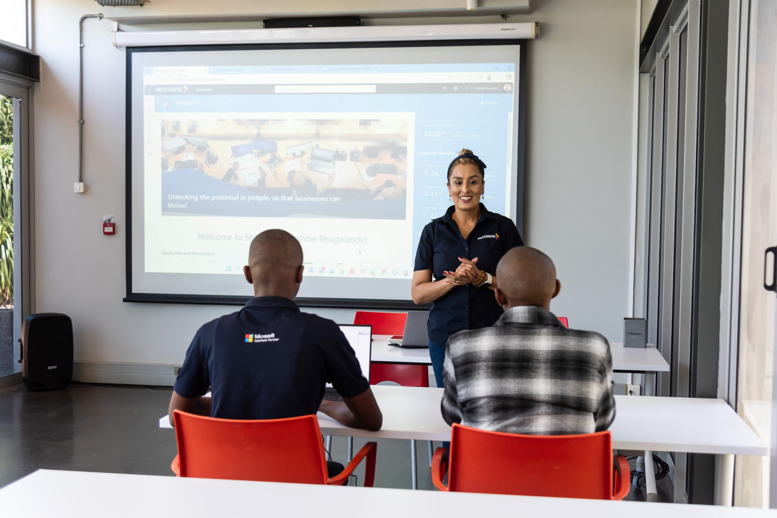 Learners working on computers during a NETCONFIG training session