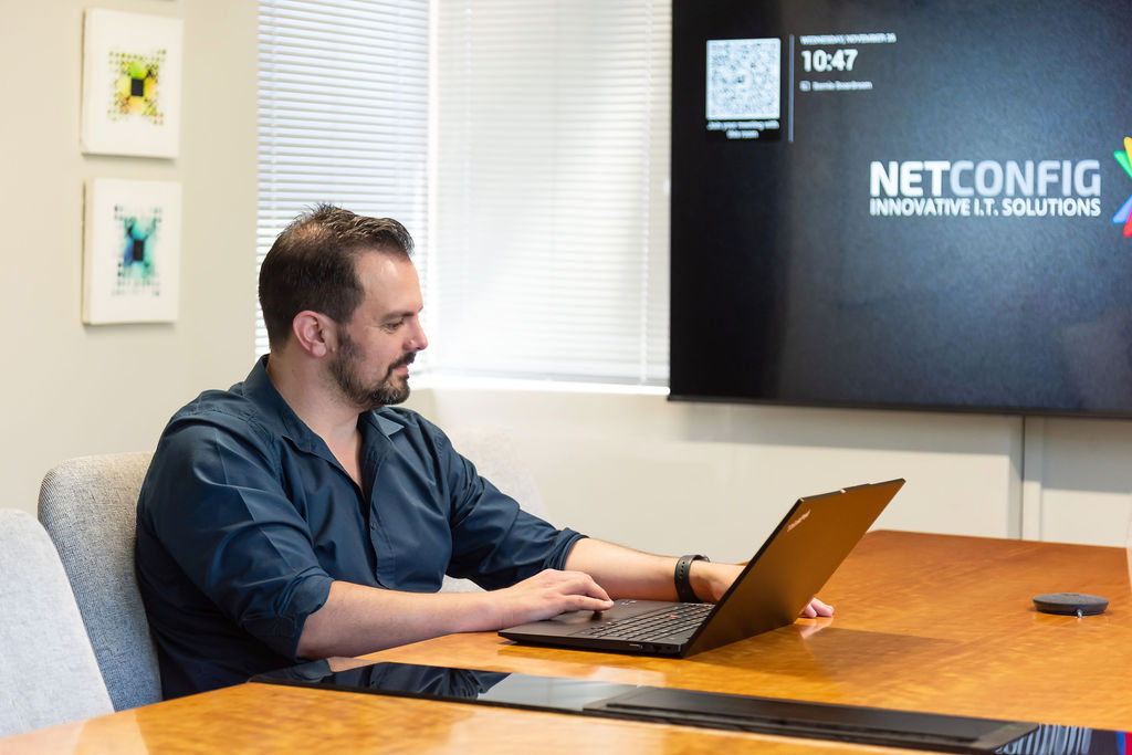 A NETCONFIG technician helping a client with their technology